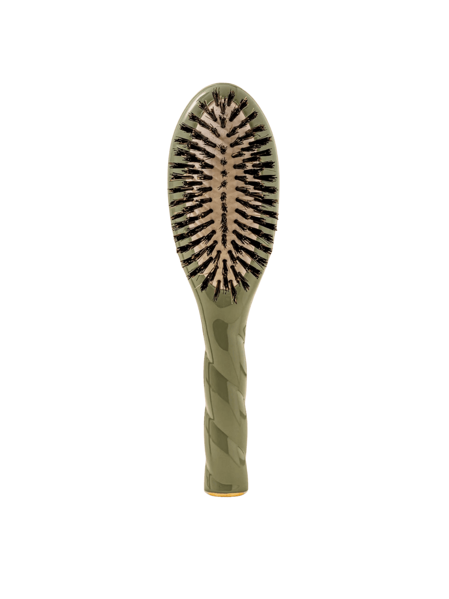 Front view of La Bonne Brosse N.01 Small The Shine & Care Hairbrush The Universal Brush in Almond Green featuring a twisted ergonomic handle and natural boar bristles | Twentyseven Toronto