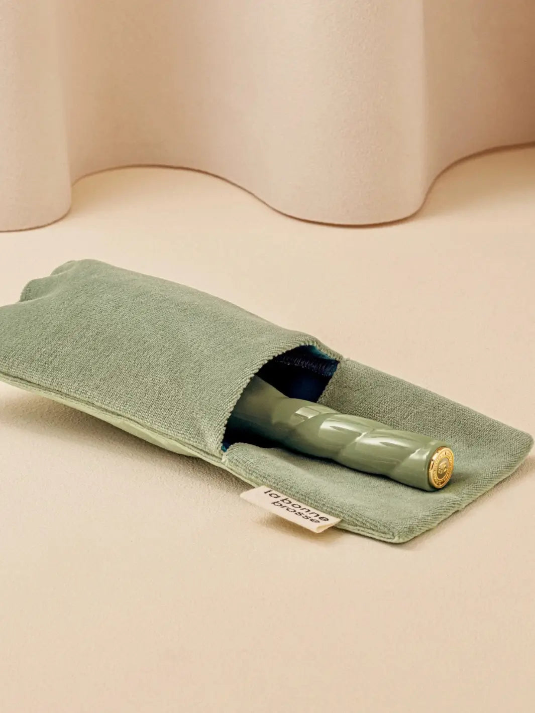 La Bonne Brosse N.01 Small The Shine & Care Hairbrush The Universal Brush in Almond Green is partially tucked into a luxurious matching green velvet travel pouch | Twentyseven Toronto