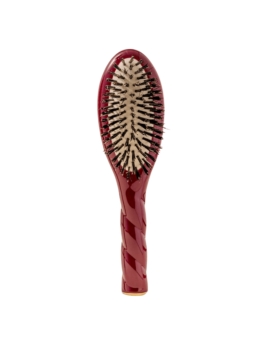Front view of La Bonne Brosse N.01 Small The Shine & Care Hairbrush The Universal Brush in Cherry Red featuring a twisted ergonomic handle and natural boar bristles | Twentyseven Toronto
