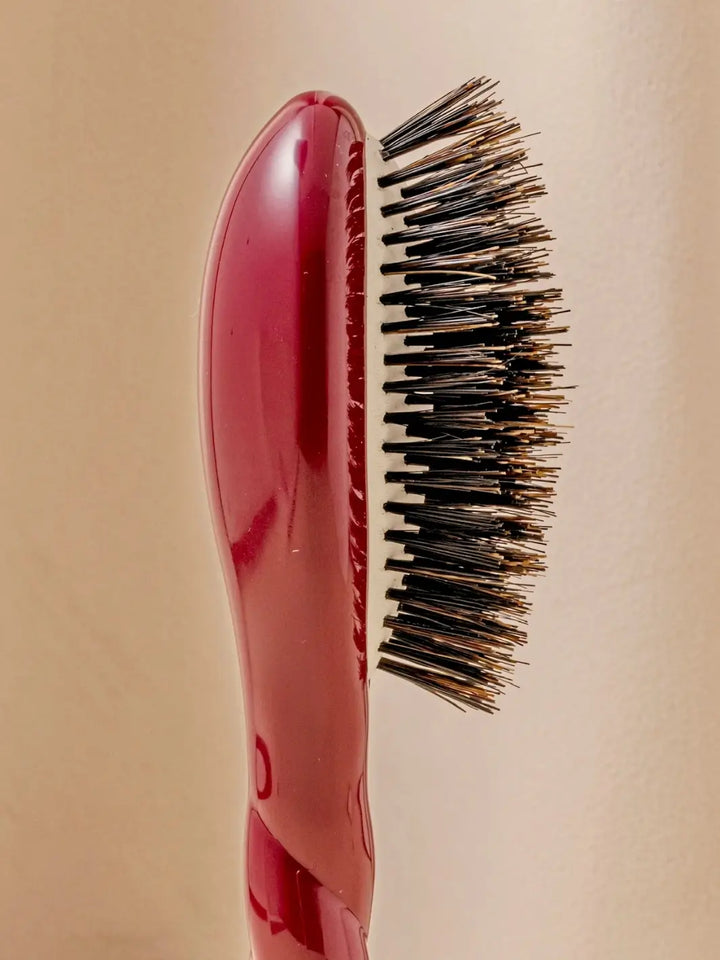 Close-up side view shot highlights the tiered bristle design of La Bonne Brosse N.01 Small The Shine & Care Hairbrush The Universal Brush in Cherry Red | Twentyseven Toronto