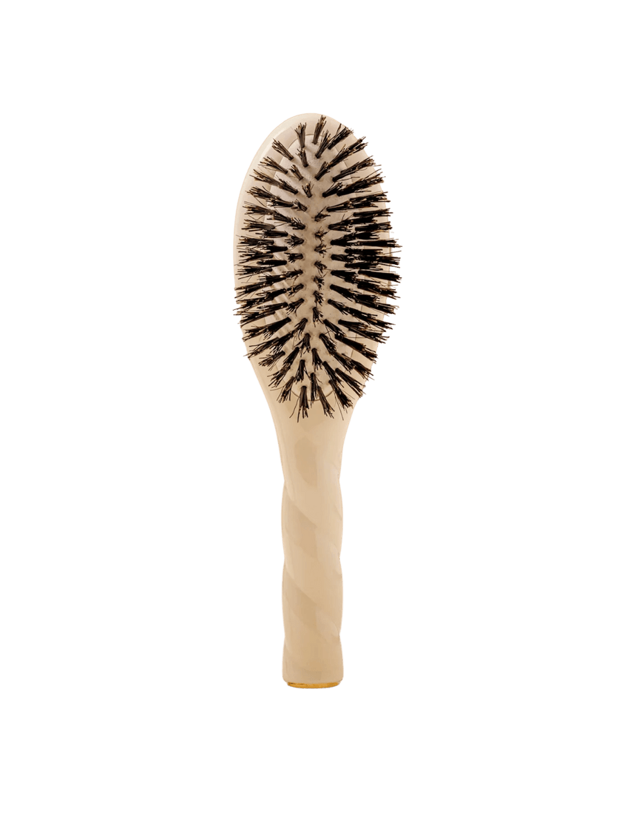 Front view of La Bonne Brosse N.01 Small The Shine & Care Hairbrush The Universal Brush in Creamy White featuring a twisted ergonomic handle and natural boar bristles | Twentyseven Toronto