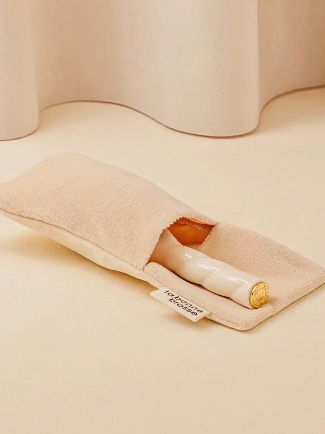 La Bonne Brosse N.01 Small The Shine & Care Hairbrush The Universal Brush in Creamy White is partially tucked into a luxurious matching white velvet travel pouch | Twentyseven Toronto