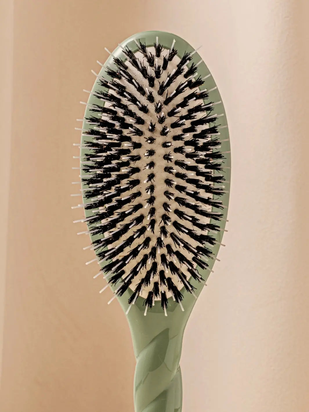 Front shot of the oval head and high-quality tufts of La Bonne Brosse N.02 Large The Essential Detangling & Conditioning Brush in Almond Green | Twentyseven Toronto