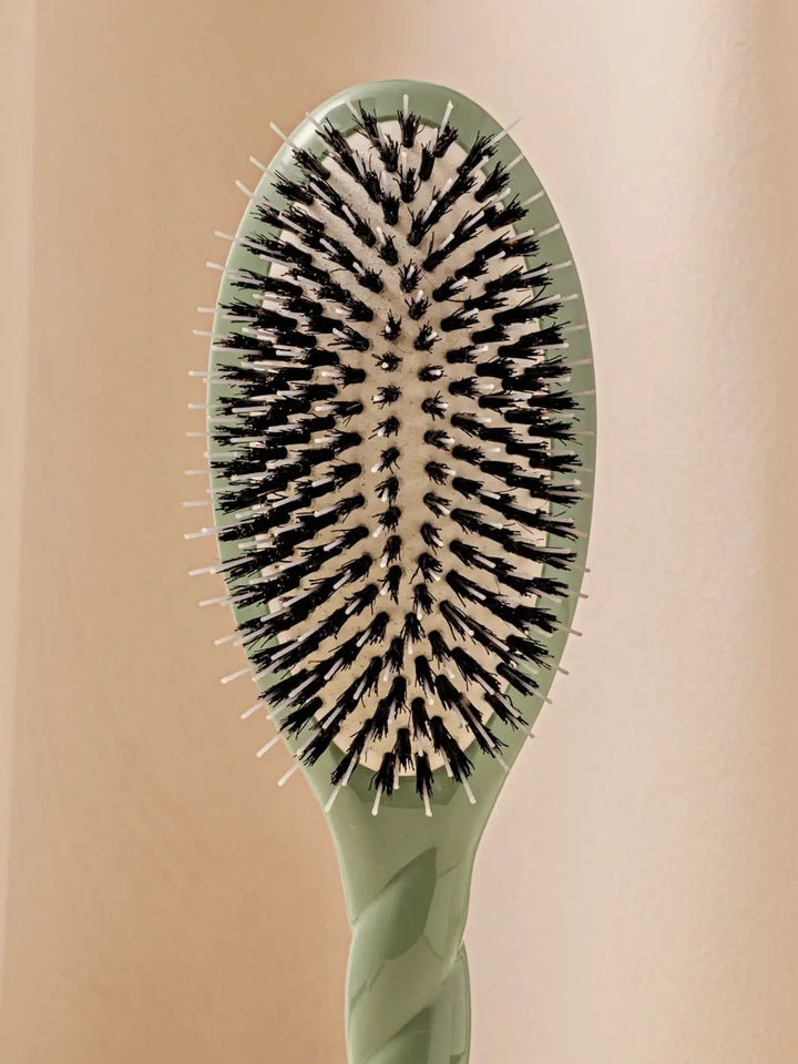 Front shot of the oval head and high-quality tufts of La Bonne Brosse N.02 Large The Essential Detangling & Conditioning Brush in Almond Green | Twentyseven Toronto