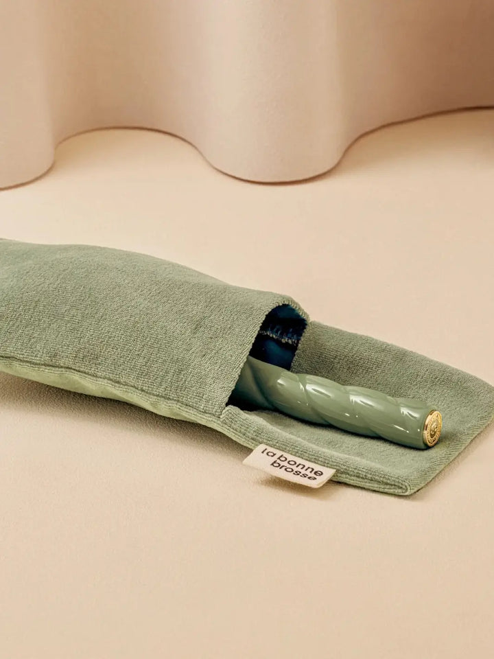 La Bonne Brosse N.02 Large The Essential Detangling & Conditioning Brush in Cherry Red is partially tucked into a luxurious matching green velvet travel pouch | Twentyseven Toronto