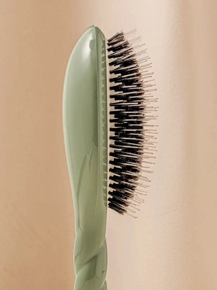 Close-up side profile shot highlights the tiered bristle design of La Bonne Brosse N.02 Large The Essential Detangling & Conditioning Brush in Almond Green | Twentyseven Toronto