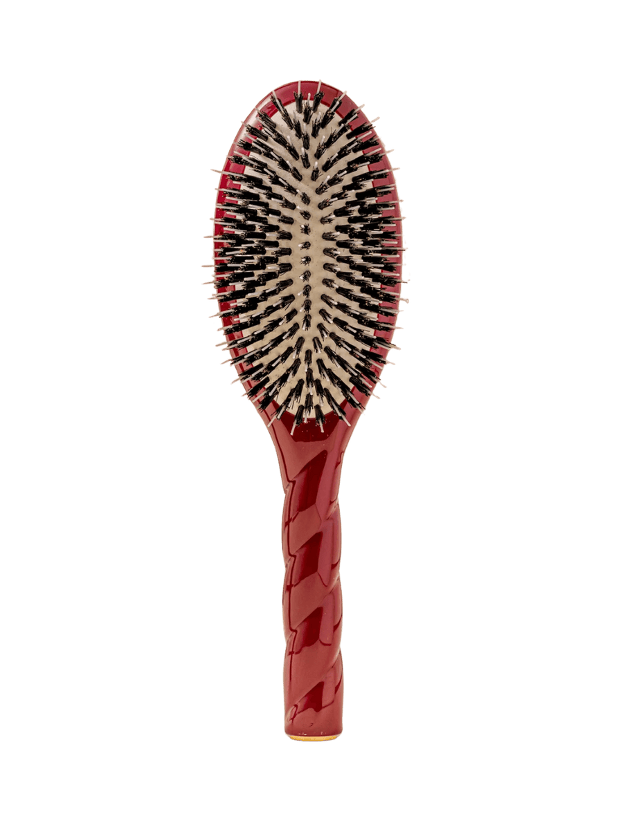 Front view of La Bonne Brosse N.02 Large The Essential Detangling & Conditioning Brush in Cherry Red featuring a twisted ergonomic handle and natural boar bristles | Twentyseven Toronto