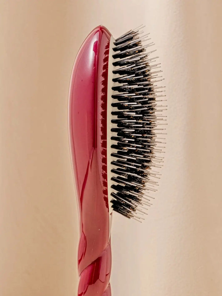 Close-up side profile shot highlights the tiered bristle design of La Bonne Brosse N.02 Large The Essential Detangling & Conditioning Brush in Cherry Red | Twentyseven Toronto