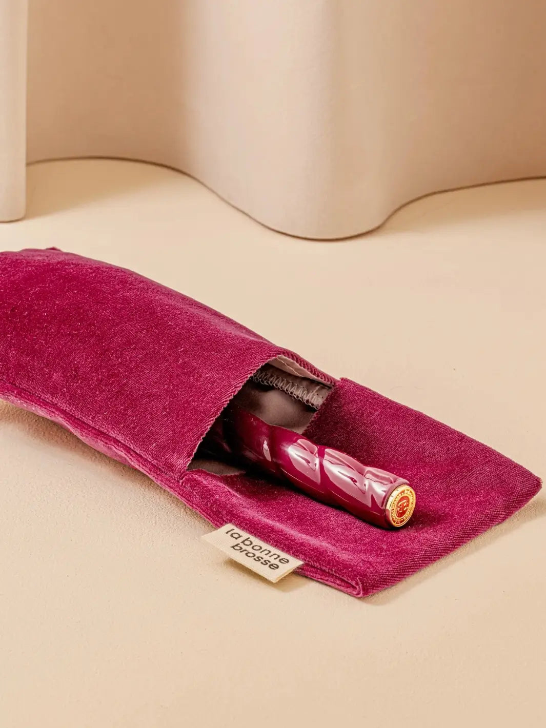 La Bonne Brosse N.02 Large The Essential Detangling & Conditioning Brush in Cherry Red is partially tucked into a luxurious matching red velvet travel pouch | Twentyseven Toronto
