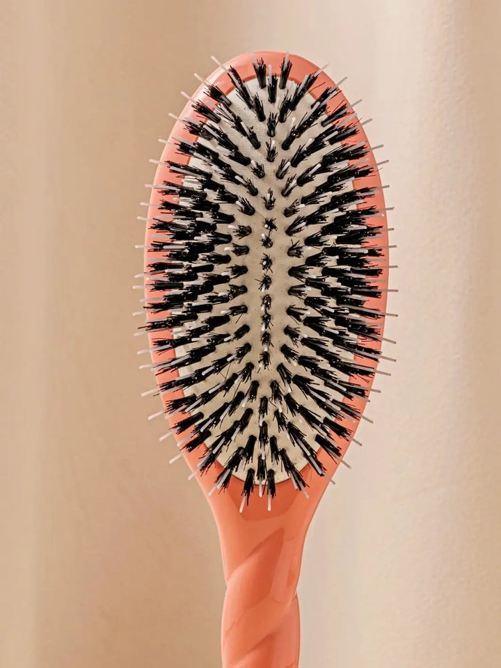 Front shot of the oval head and high-quality tufts of La Bonne Brosse N.02 Large The Essential Detangling & Conditioning Brush in Orange Coral | Twentyseven Toronto