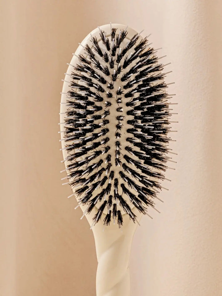 Front shot of the oval head and high-quality tufts of La Bonne Brosse N.02 Large The Essential Detangling & Conditioning Brush in Creamy White | Twentyseven Toronto