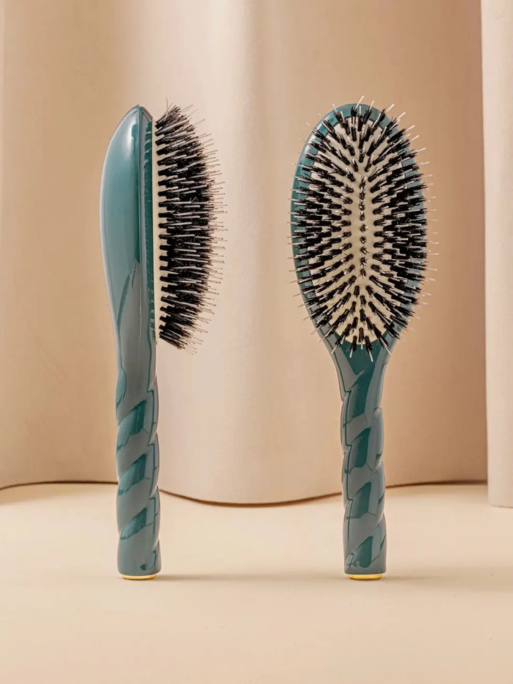 Front and side view of La Bonne Brosse N.02 Large The Essential Detangling & Conditioning Brush in Ink Blue featuring a twisted ergonomic handle and natural boar bristles | Twentyseven Toronto