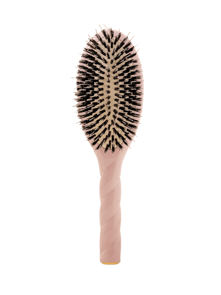 Front view of La Bonne Brosse N.02 Large The Essential Detangling & Conditioning Brush in Lilac Pink featuring a twisted ergonomic handle and natural boar bristles | Twentyseven Toronto