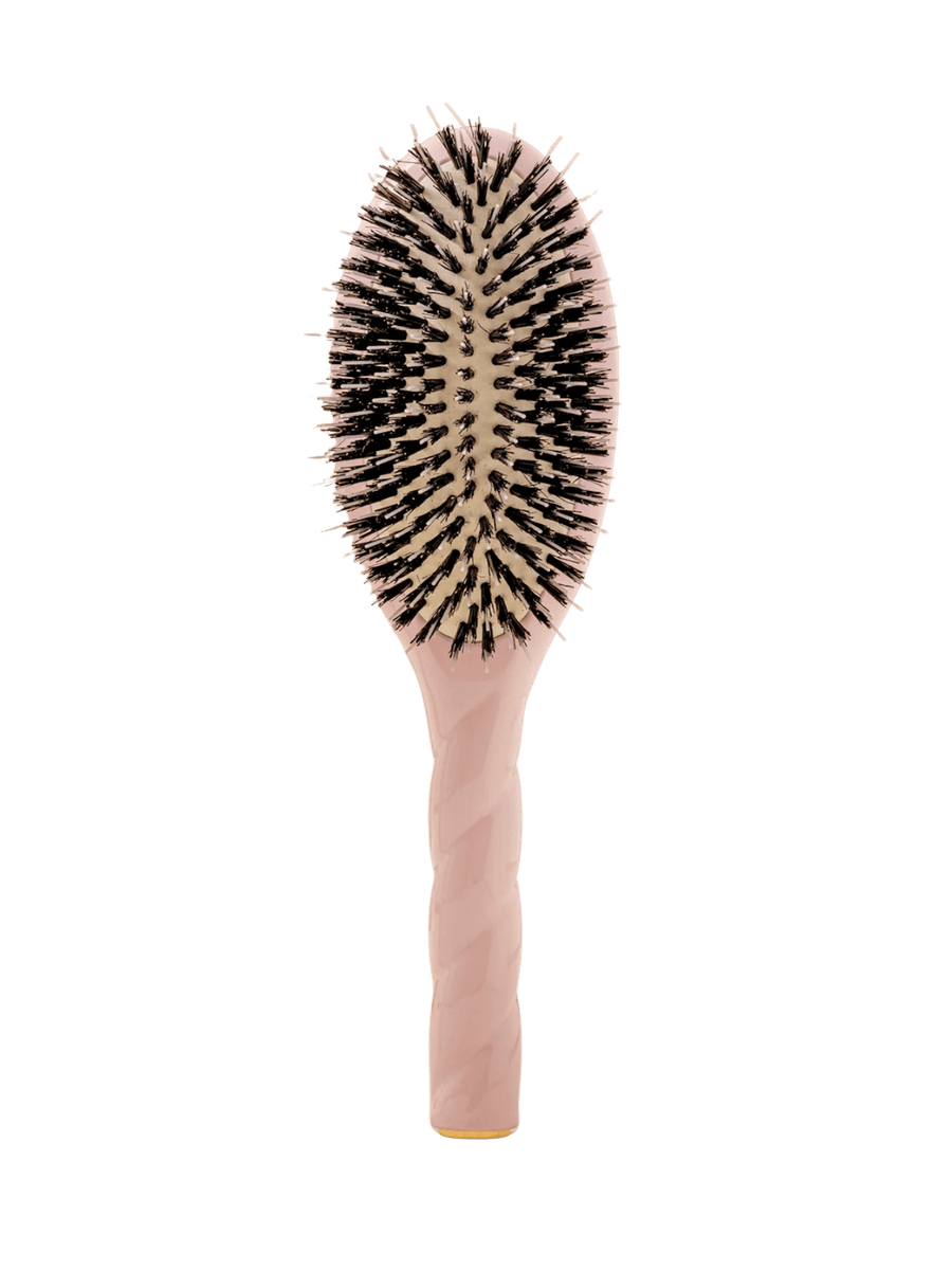 Front view of La Bonne Brosse N.02 Large The Essential Detangling & Conditioning Brush in Lilac Pink featuring a twisted ergonomic handle and natural boar bristles | Twentyseven Toronto