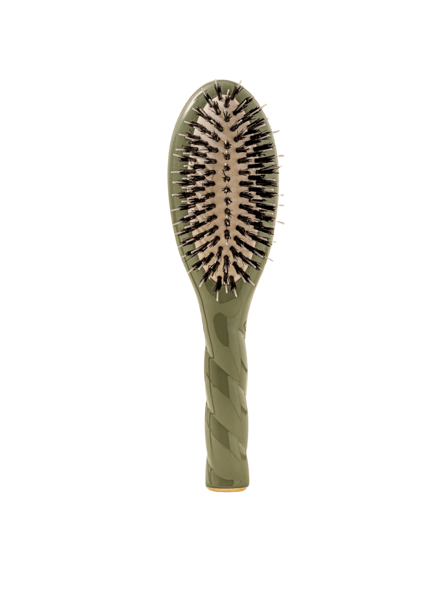 Front view of La Bonne Brosse N.02 Small The Essential Detangling & Conditioning Brush in Almond Green featuring a twisted ergonomic handle and natural boar and nylon bristles | Twentyseven Toronto