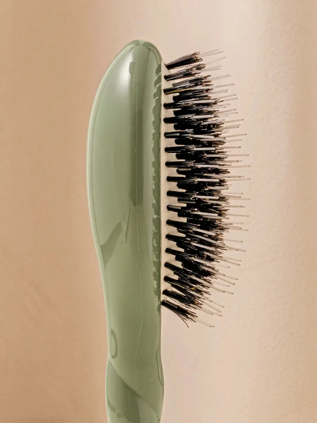 Close-up side profile shot highlights the tiered bristle design of La Bonne Brosse N.02 Small The Essential Detangling & Conditioning Brush in Almond Green | Twentyseven Toronto