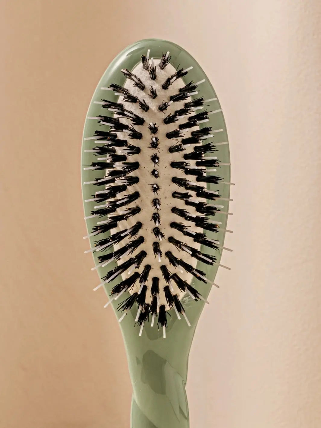 Front shot of the oval head and high-quality tufts of La Bonne Brosse N.02 Small The Essential Detangling & Conditioning Brush in Cherry Red | Twentyseven Toronto