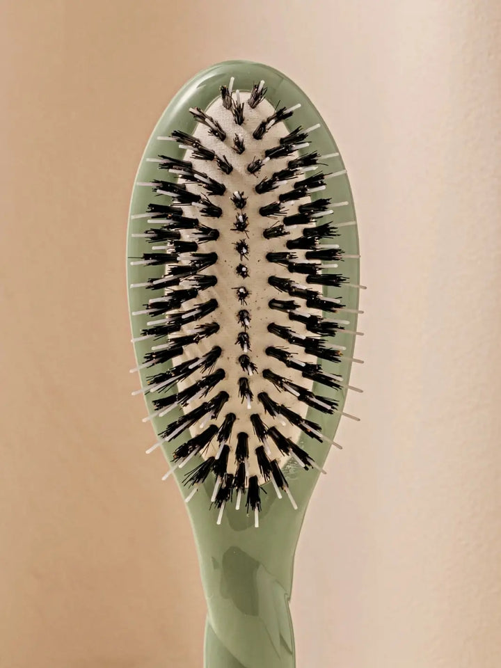 Front shot of the oval head and high-quality tufts of La Bonne Brosse N.02 Small The Essential Detangling & Conditioning Brush in Cherry Red | Twentyseven Toronto
