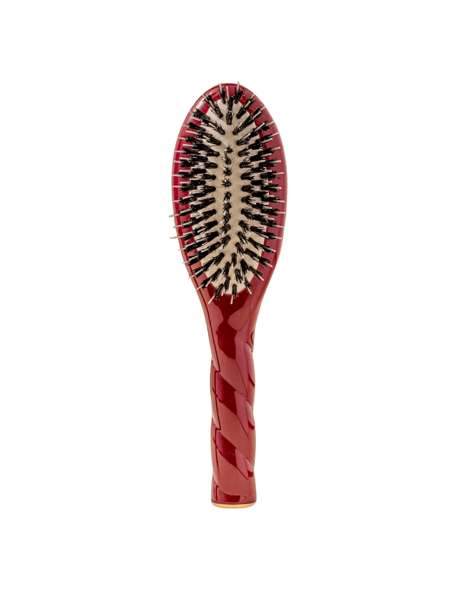 Front view of La Bonne Brosse N.02 Small The Essential Detangling & Conditioning Brush in Cherry Red featuring a twisted ergonomic handle and natural boar and nylon bristles | Twentyseven Toronto