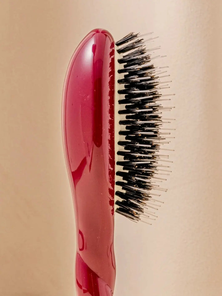 Close-up side profile shot highlights the tiered bristle design of La Bonne Brosse N.02 Small The Essential Detangling & Conditioning Brush in Cherry Red | Twentyseven Toronto