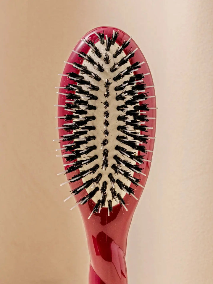 Front shot of the oval head and high-quality tufts of La Bonne Brosse N.02 Small The Essential Detangling & Conditioning Brush in Cherry Red | Twentyseven Toronto