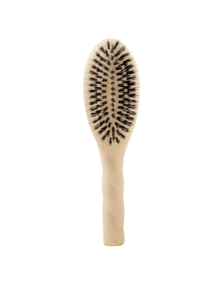 Front view of La Bonne Brosse N.02 Small The Essential Detangling & Conditioning Brush in Creamy White featuring a twisted ergonomic handle and natural boar and nylon bristles | Twentyseven Toronto