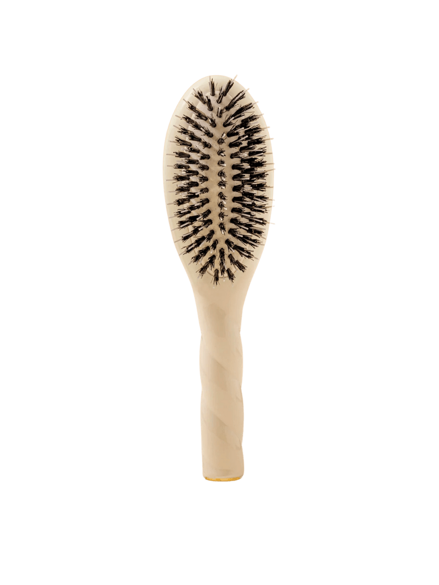 Front view of La Bonne Brosse N.02 Small The Essential Detangling & Conditioning Brush in Creamy White featuring a twisted ergonomic handle and natural boar and nylon bristles | Twentyseven Toronto