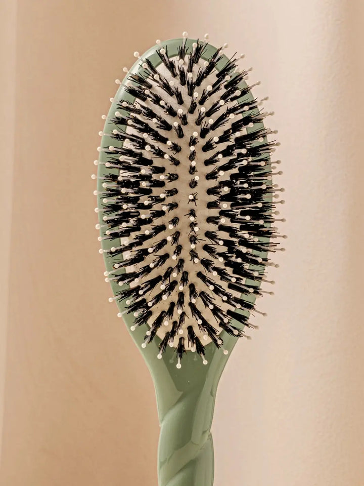 Close up front shot of La Bonne Brosse N.03 Large The Essential Softness & Sensitive Scalp Brush in Almond Green | Twentyseven Toronto