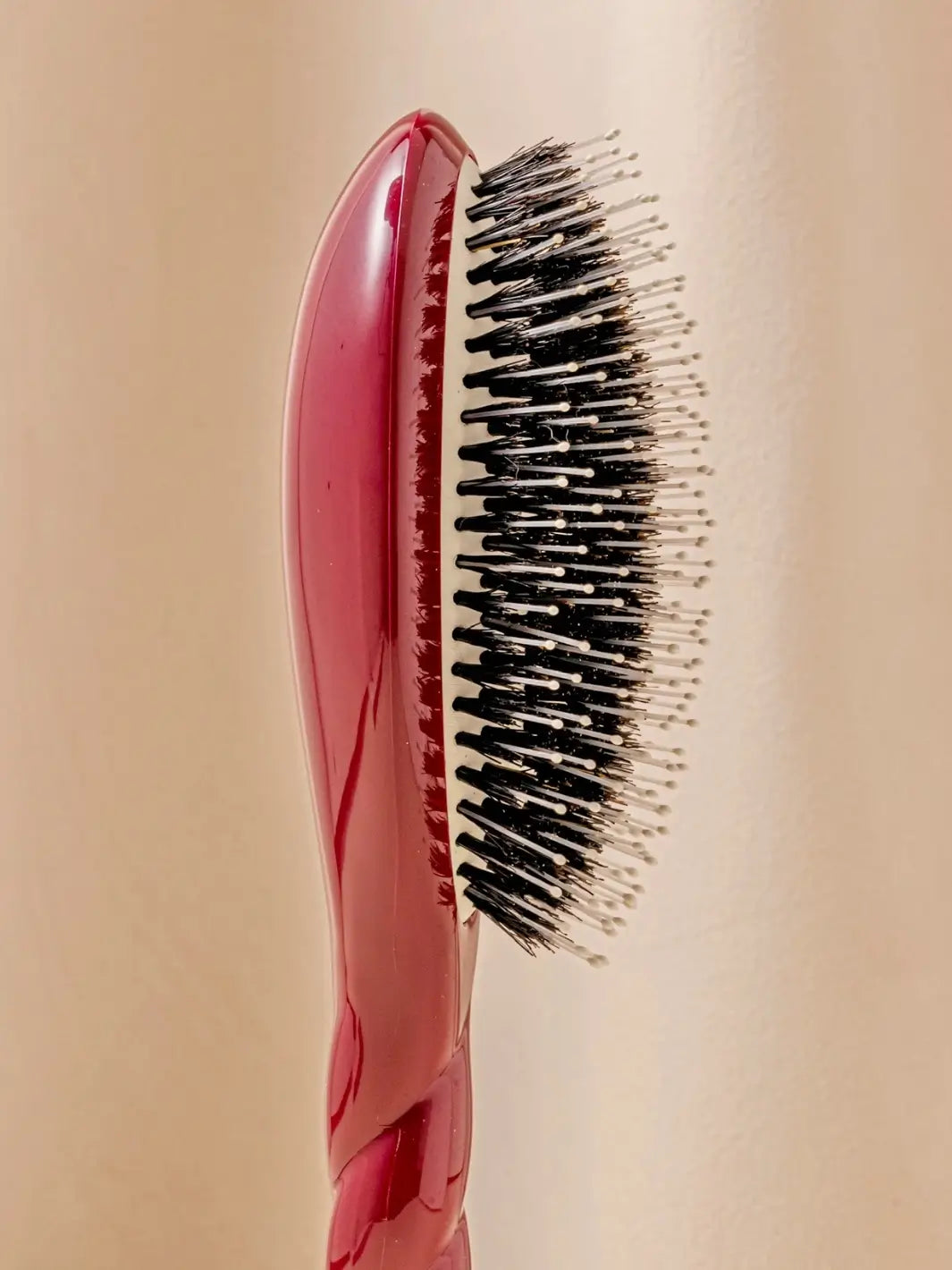 Close-up side profile image highlights the tiered bristle design of La Bonne Brosse N.03 Large The Essential Softness & Sensitive Scalp Brush in Cherry Red  | Twentyseven Toronto