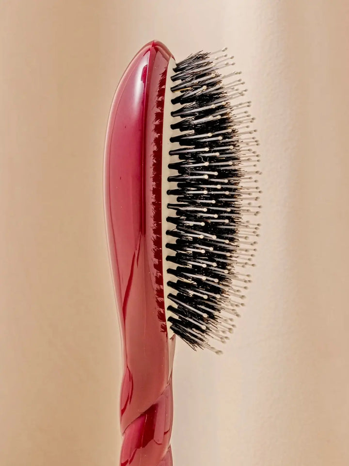 Close-up side profile image highlights the tiered bristle design of La Bonne Brosse N.03 Large The Essential Softness & Sensitive Scalp Brush in Cherry Red  | Twentyseven Toronto