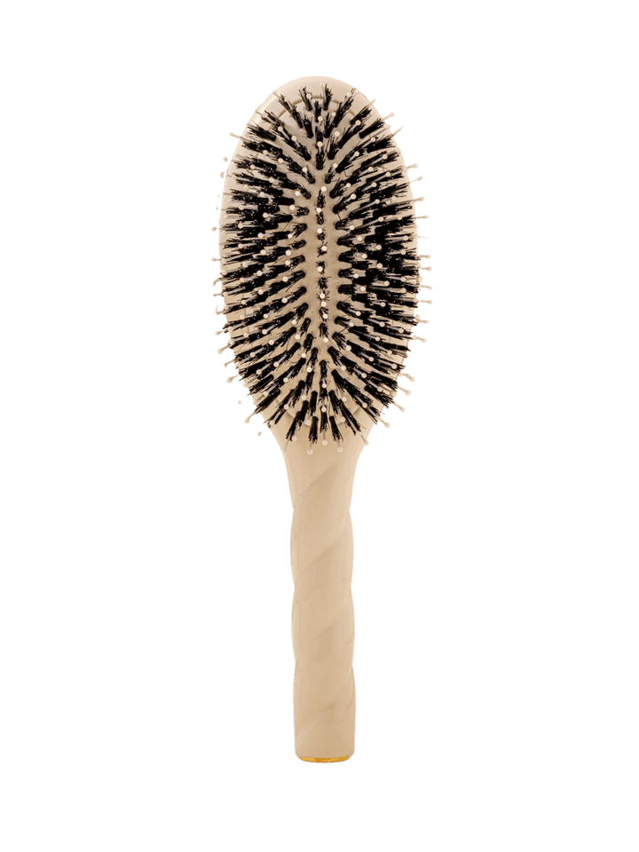 Front view of La Bonne Brosse N.03  Large The Essential Softness & Sensitive Scalp Brush in Creamy White featuring a twisted ergonomic handle, boar bristle and nylon hairbrush | Twentyseven Toronto