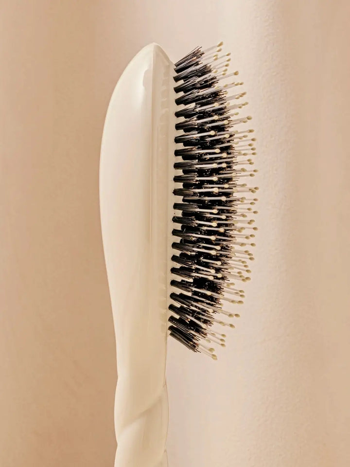 Close-up side image highlights the tiered bristle design of La Bonne Brosse N.03 Large The Essential Softness & Sensitive Scalp Brush in Creamy White | Twentyseven Toronto