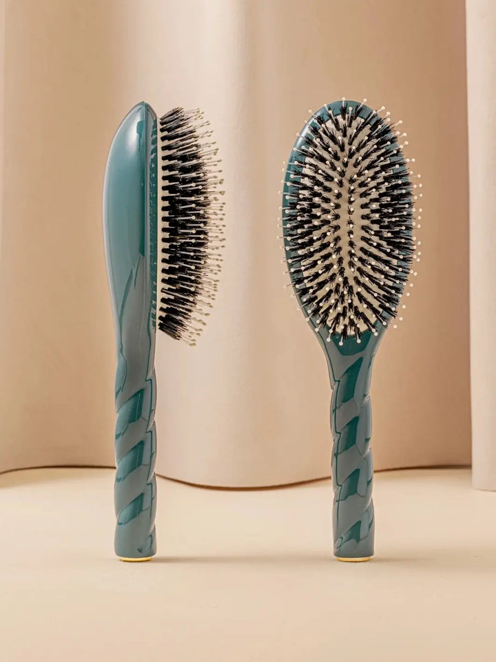 Front and side view of La Bonne Brosse N.03 Large The Essential Softness & Sensitive Scalp Brush in Ink Blue featuring a twisted ergonomic handle and natural boar bristles | Twentyseven Toronto