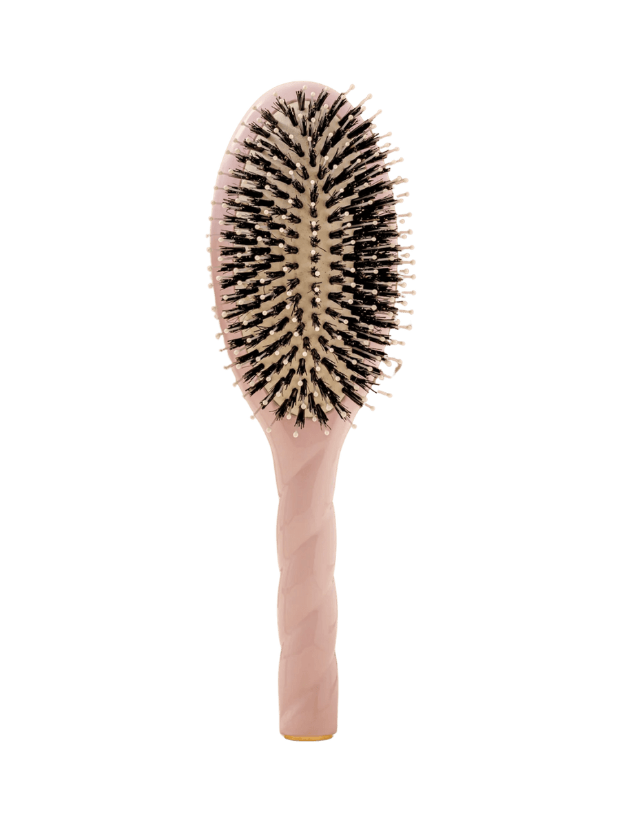Front view of La Bonne Brosse N.03  Large The Essential Softness & Sensitive Scalp Brush in Lilac Pink featuring a twisted ergonomic handle, boar bristle and nylon hairbrush | Twentyseven Toronto