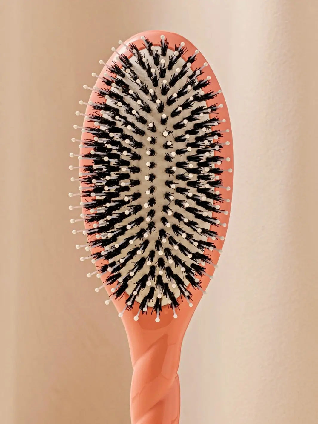 Close up front shot of La Bonne Brosse N.03 Large The Essential Softness & Sensitive Scalp Brush in Orange Coral | Twentyseven Toronto