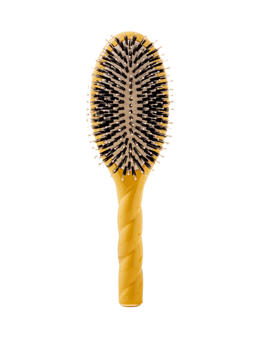 Front view of La Bonne Brosse N.03  Large The Essential Softness & Sensitive Scalp Brush in Saffron Yellow featuring a twisted ergonomic handle, boar bristle and nylon hairbrush | Twentyseven Toronto