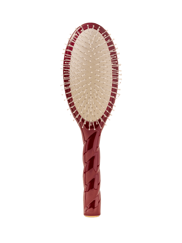Front view of La Bonne Brosse N.04 Large The Detangling & Massaging Miracle Brush in Cherry Red featuring a twisted ergonomic handle and nylon bristles | Twentyseven Toronto