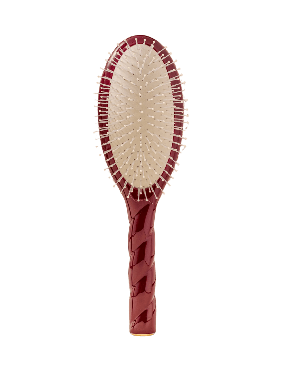Front view of La Bonne Brosse N.04 Large The Detangling & Massaging Miracle Brush in Cherry Red featuring a twisted ergonomic handle and nylon bristles | Twentyseven Toronto