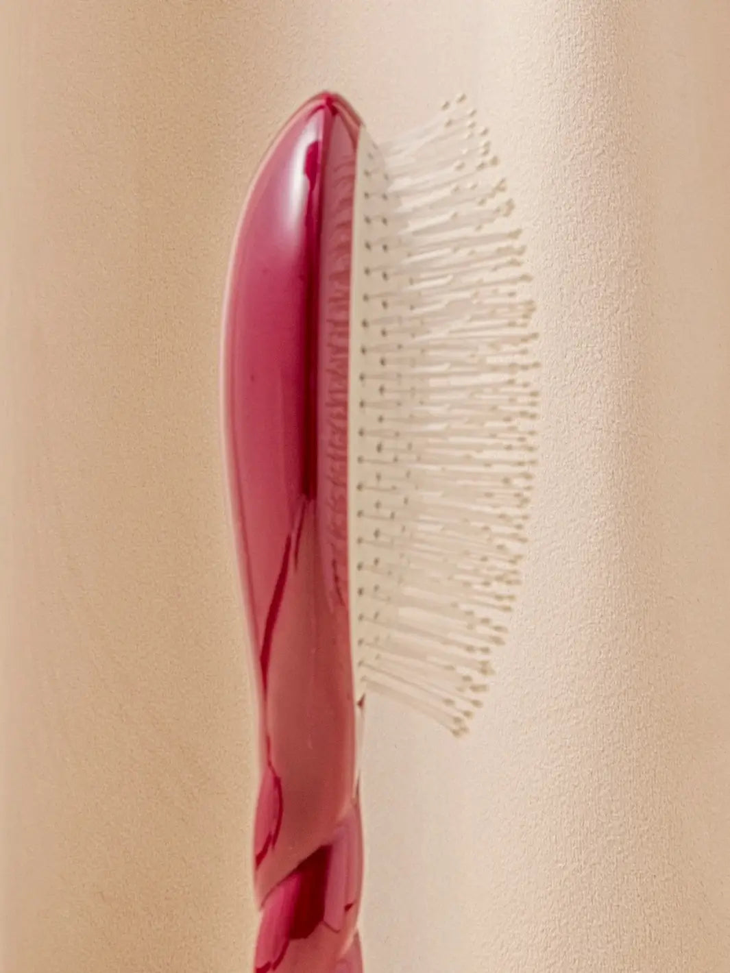 Close-up side view image highlights the nylon bristles of La Bonne Brosse N.04 Large The Detangling & Massaging Miracle Brush in Cherry Red  | Twentyseven Toronto