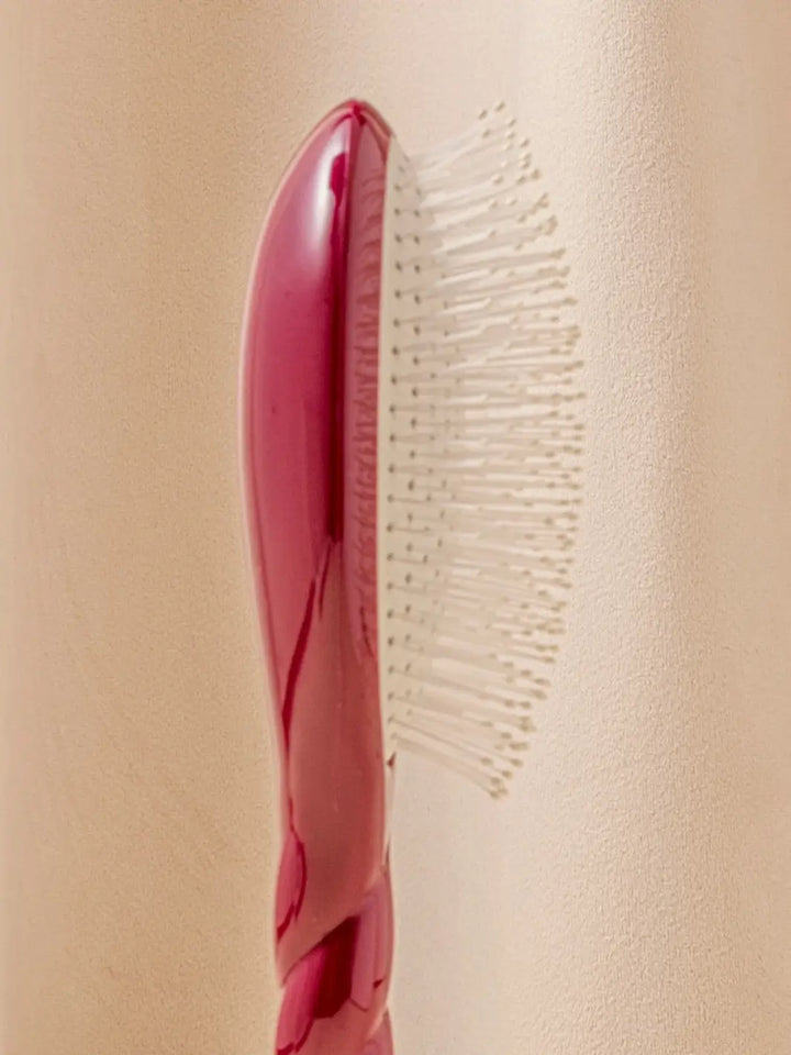 Close-up side view image highlights the nylon bristles of La Bonne Brosse N.04 Large The Detangling & Massaging Miracle Brush in Cherry Red  | Twentyseven Toronto