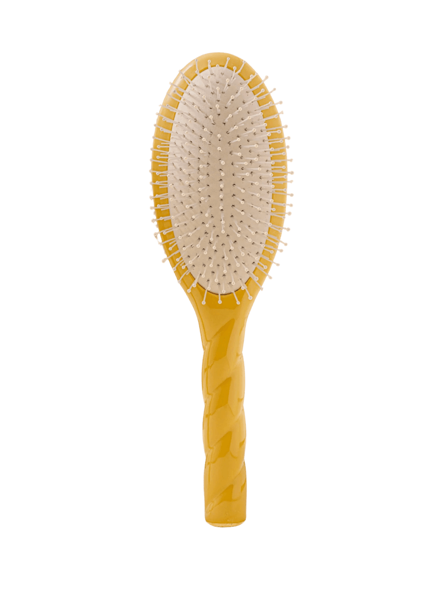 Front view of La Bonne Brosse N.04 Large The Detangling & Massaging Miracle Brush in Saffron Yellow featuring a twisted ergonomic handle and nylon bristles | Twentyseven Toronto