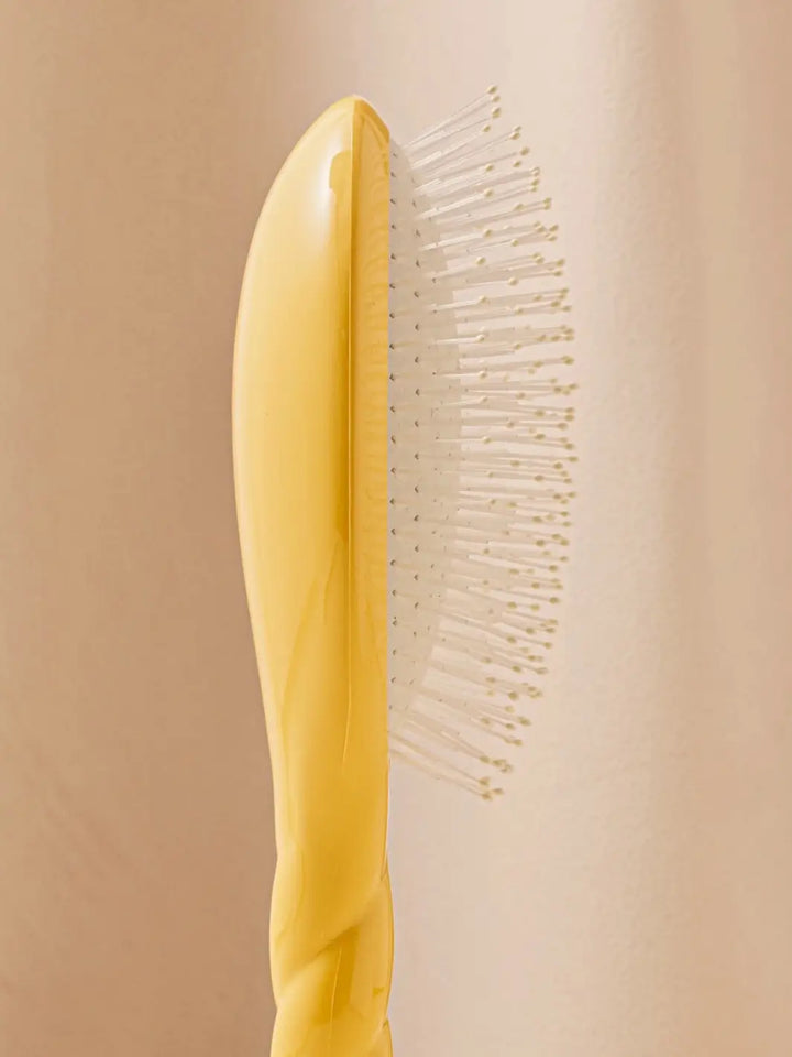 Close-up side view image highlights the nylon bristles of La Bonne Brosse N.04 Large The Detangling & Massaging Miracle Brush in Saffron Yellow  | Twentyseven Toronto