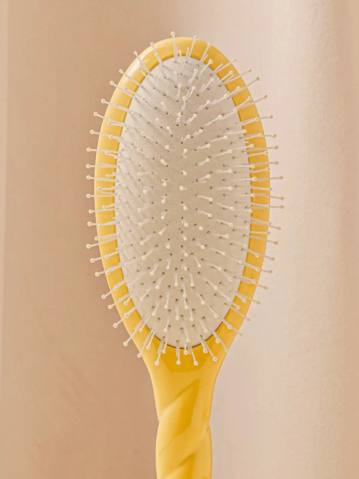 Close up front shot of La Bonne Brosse N.04 Large The Detangling & Massaging Miracle Brush in Saffron Yellow featuring nylon bristles | Twentyseven Toronto