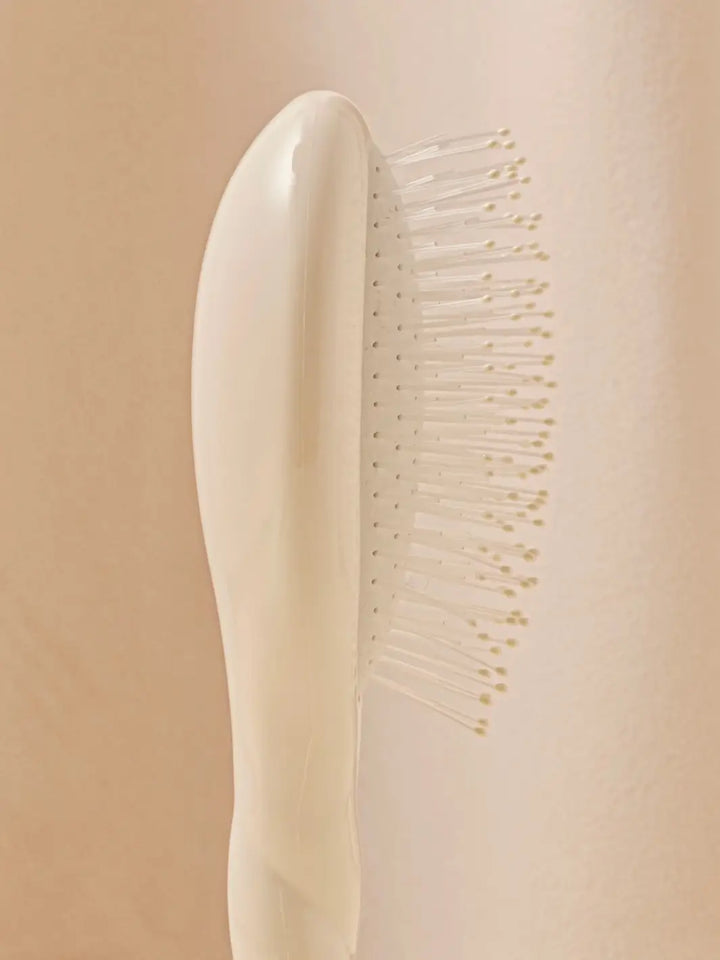 Close-up side view image highlights the nylon bristles of La Bonne Brosse N.04 Small The Detangling & Massaging Miracle Brush in Creamy White  | Twentyseven Toronto