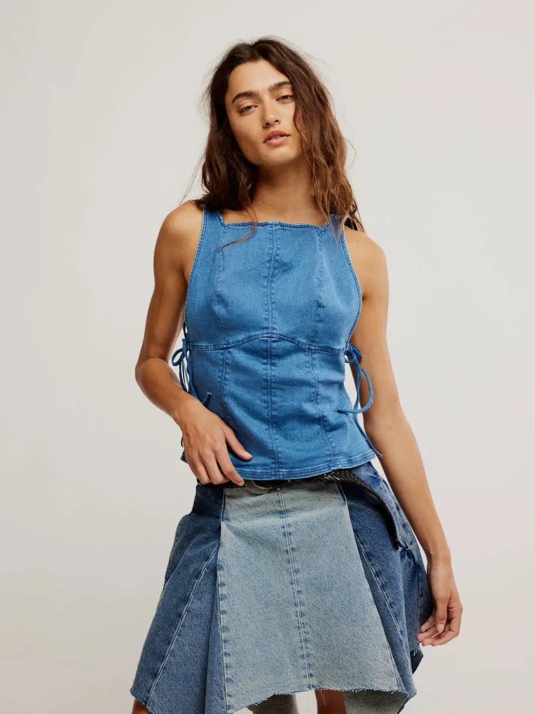 A model stands from the front to showcase the square neckline, contoured panel stitching, and supportive fit of the Free People Not My Fault Corset - Denim Baby Blue | Twentyseven Toronto