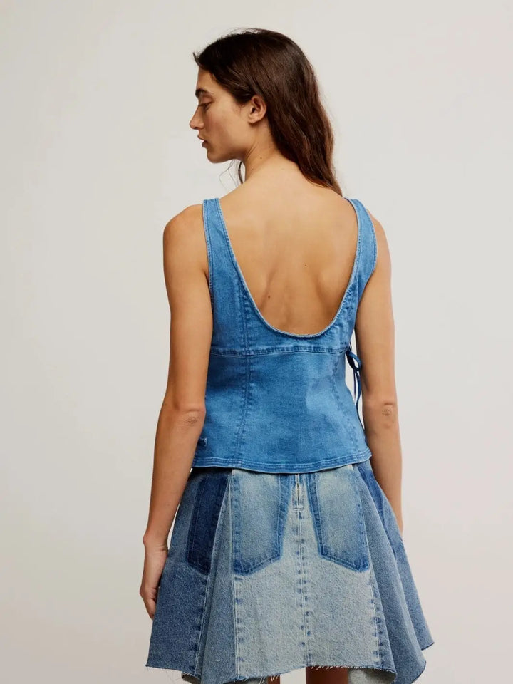 A rear view highlights the deep scoop back, clean seam panels, and sleeveless silhouette of the Free People Not My Fault Corset - Denim Baby Blue | Twentyseven Toronto