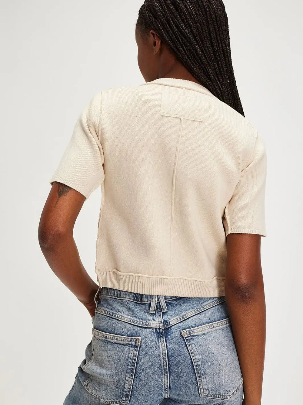 A view from behind highlights the classic crew neckline, cropped hemline, and distinct vertical back seam of the cream-colored Free People We The Free NY Twosie - Ecru | Twentyseven Toronto