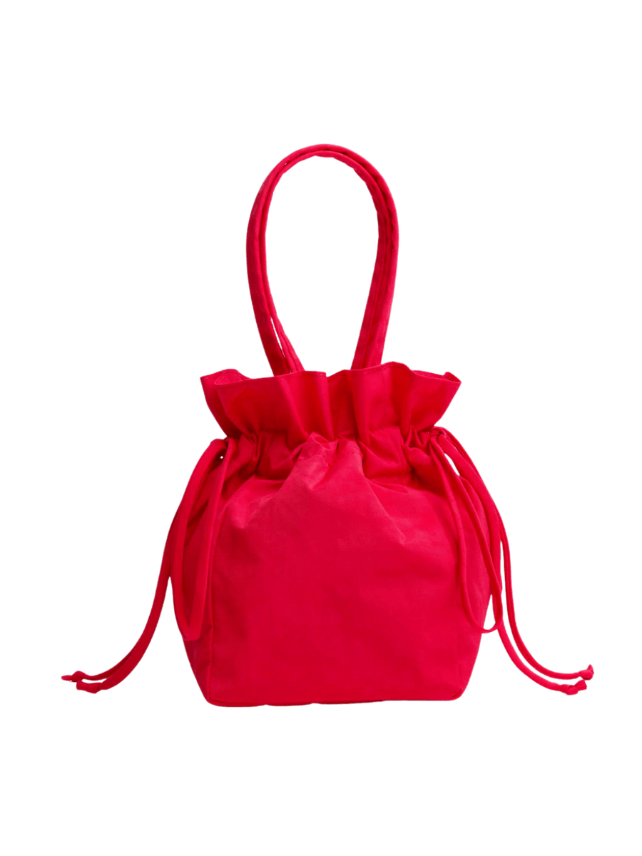 Red BAGGU Nylon Drawstring Bag in Candy Apple with ruffled drawstring top and dual carry handles against a transparent background | Twentyseven Toronto