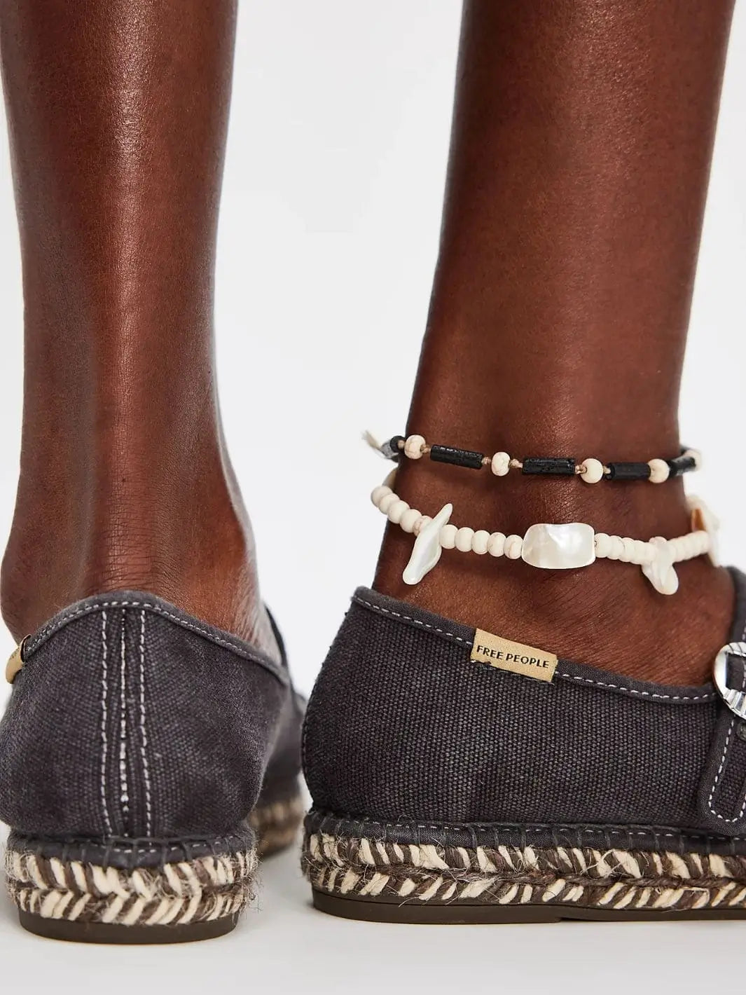 A rear view highlights the stitched back seam and the supportive heel cup of the Free People Oasis Mary Jane Espadrilles - Washed Black | Twentyseven Toronto
