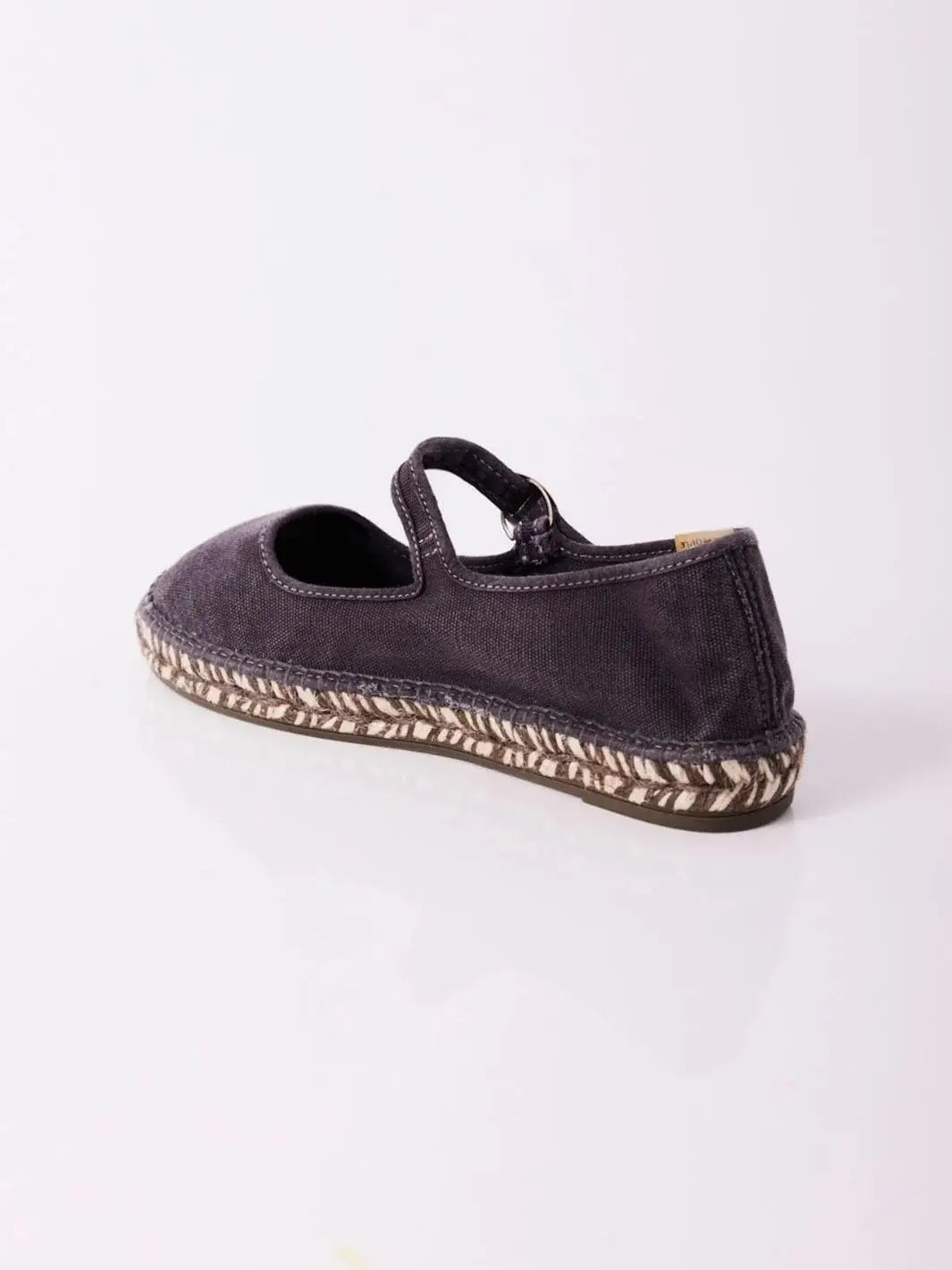 A rear studio product angle shows the back heel structure and patterned midsole stitching of the Free People Oasis Mary Jane Espadrilles - Washed Black | Twentyseven Toronto